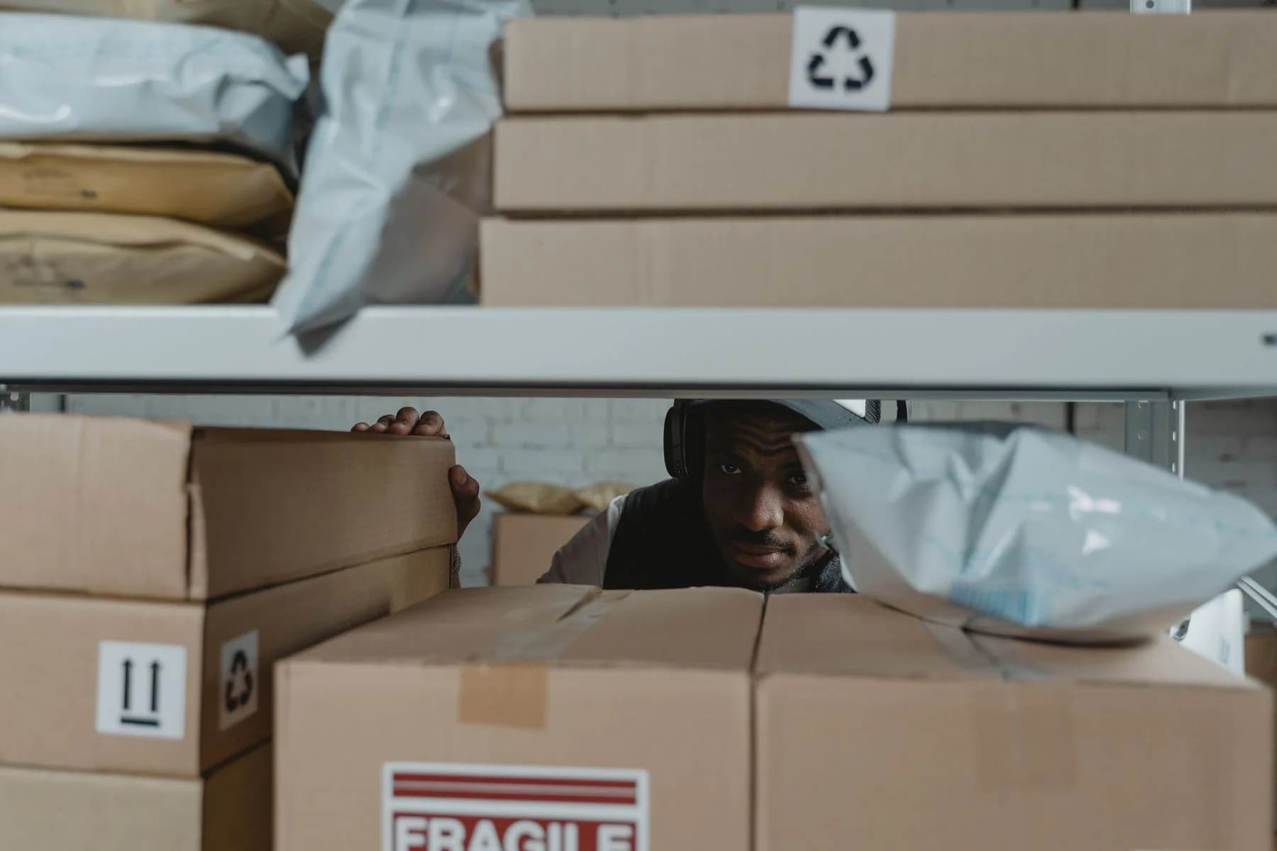 A person checking parcels in a real warehouse setting