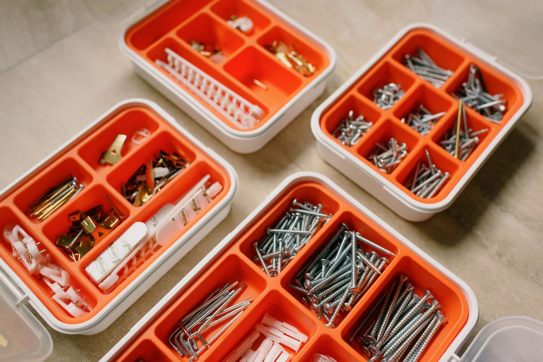Sorting boxes containing screws, nails, and wall plugs in a real workshop