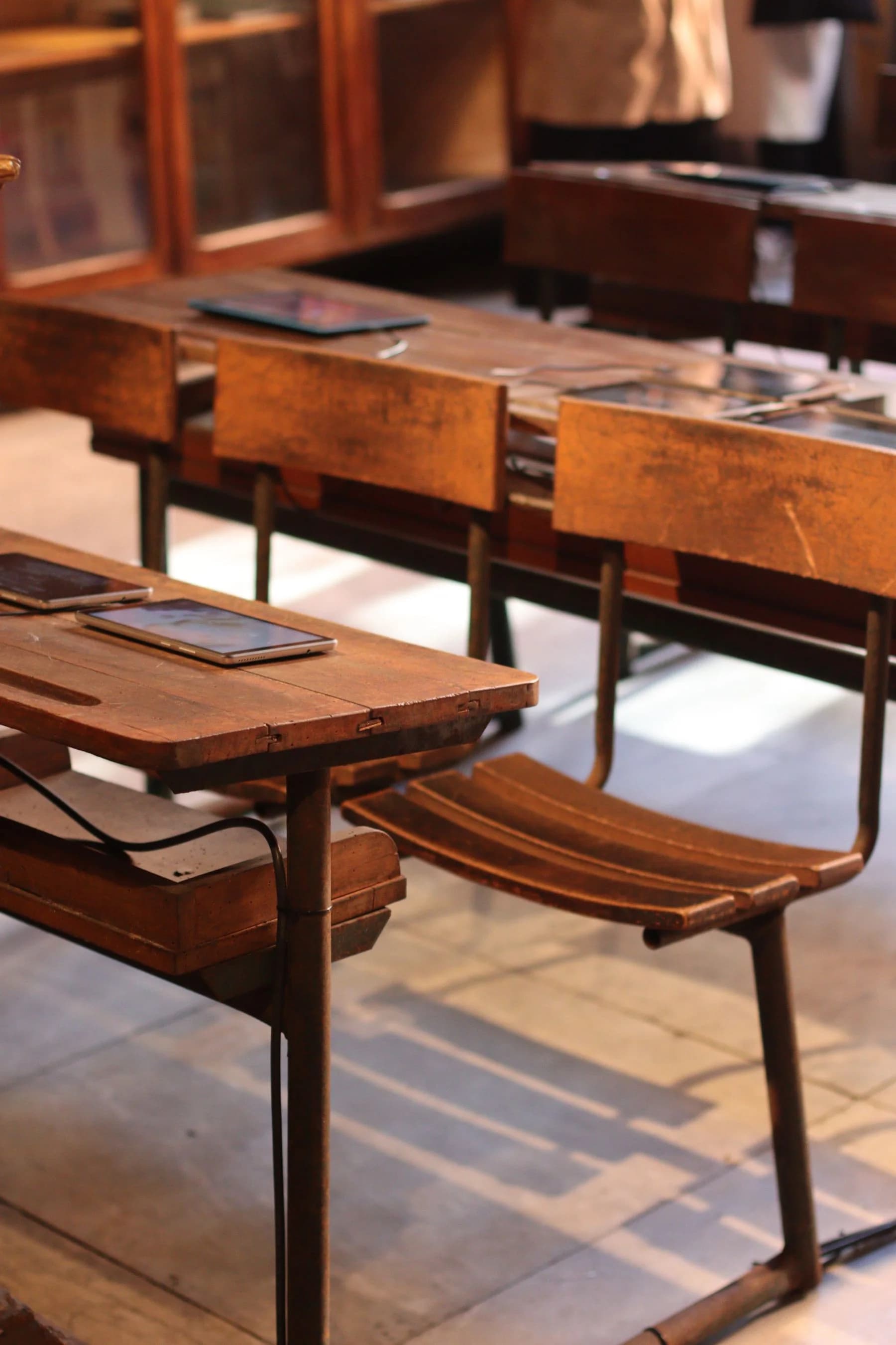 Several tablets on desks in a real classroom