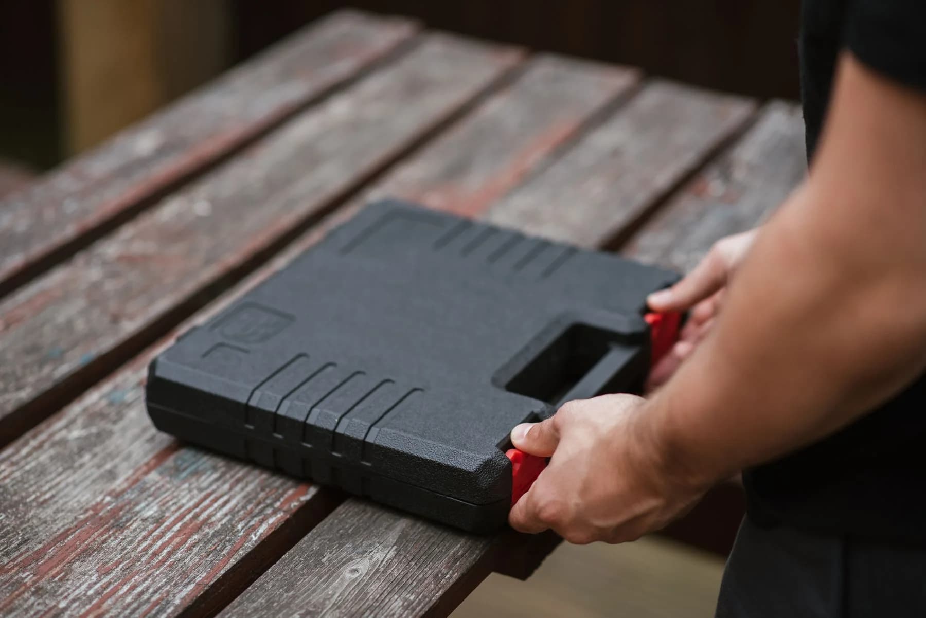 A person opening or closing a robust tool case
